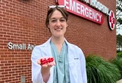 Photo of Dr. Meagan Walker, veterinarian, holding her drill guide
