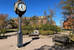 photo of clock in bricked plaza on campus