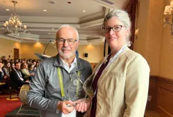 Dr. Rhonda Hamilton (R) receives the Atlantic Award of Excellence from Dr. Ernie Prowse (L), chair of the Atlantic Provinces Veterinary Conference.