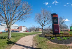 Vertical sign in front of campus with blue sky 