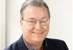 Photo of person wearing glasses and smiling