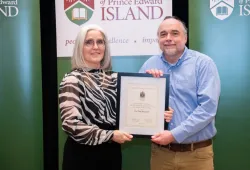 Dr. Wendy Rodgers, UPEI president and vice-chancellor, presents the award to Dr. Paul Bernard