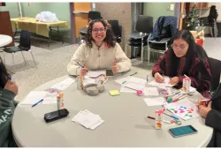 Students creating UPEI holiday cards in 2024.