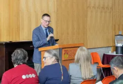 photo of man speaking at a podium