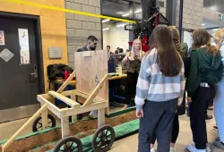Woman describing equipment to a group of women students