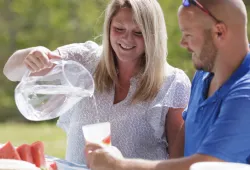 An Island couple enjoys a non-alcoholic beverage outdoors.