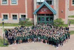Large group of student-athletes gathered in front of the Sports Centre
