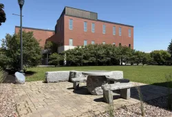 photo of stone terrace with building in the background during summer