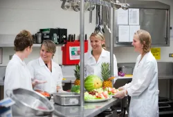 four dietitians preparing a fruit tray