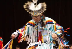 a dancer in traditional Indigenous dress