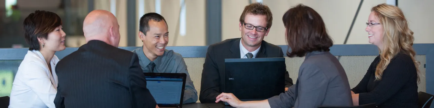 a group of people at a boardroom table