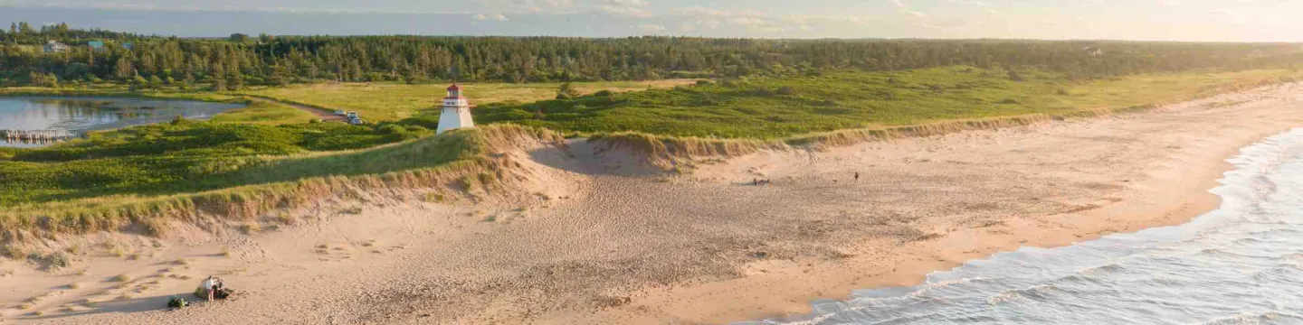 drone image of a PEI shoreline with a lighthouse