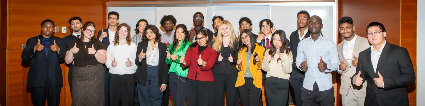 a large group of smiling students at night