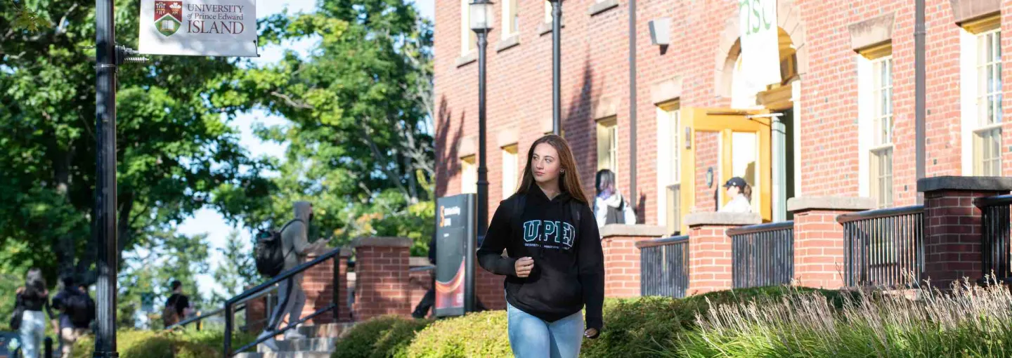 a student walking in front of SDU Main Building