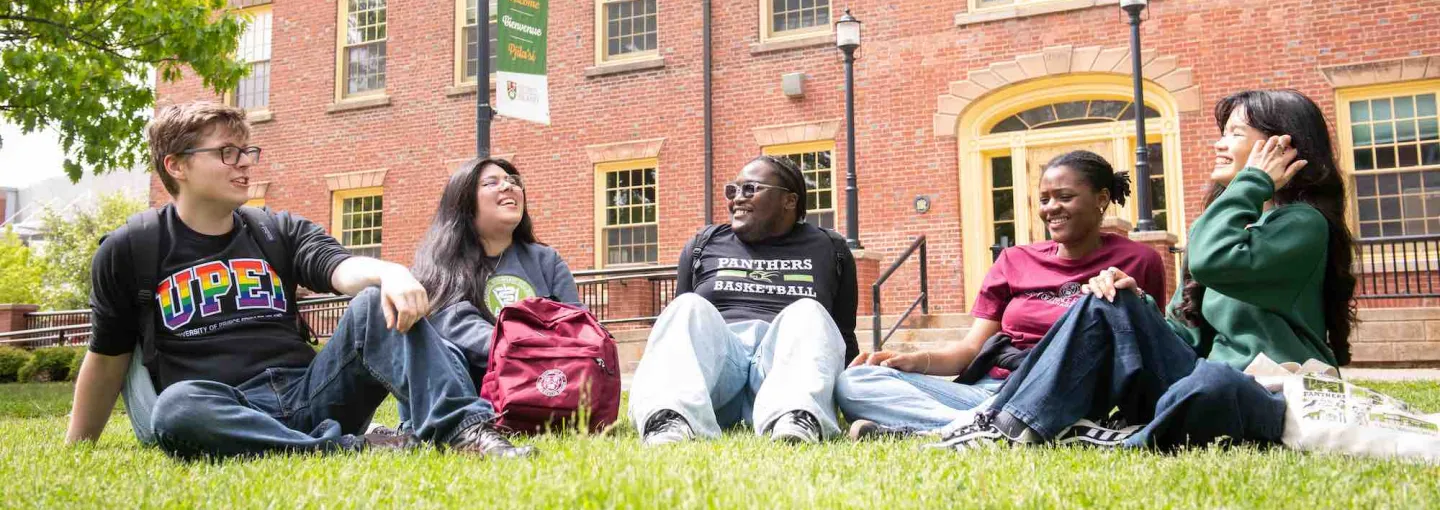 five students sitting in the UPEI quad