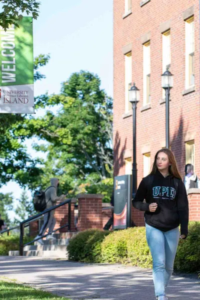 a student walking in front of SDU Main Building