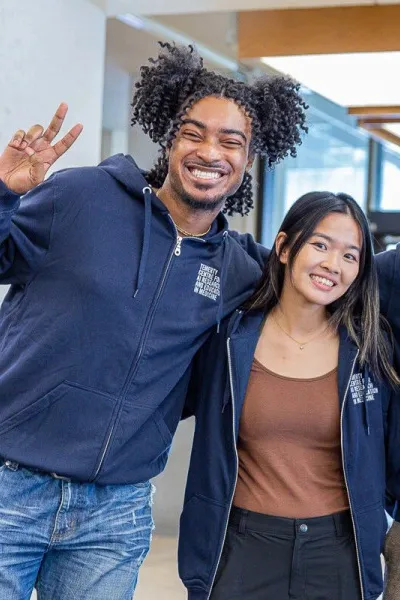 smiling students in a conference room