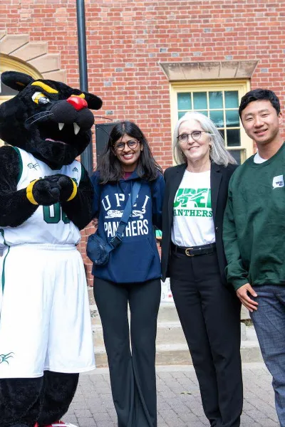 a group of people and Pride the Panther in front of SDU Main Building