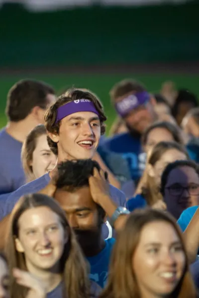 a group of smiling students at night