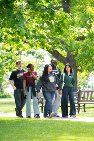five students walking in the UPEI quad