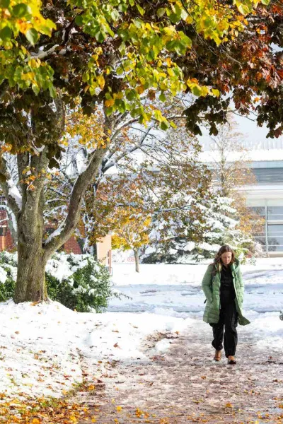 a student walking on campus in the winter