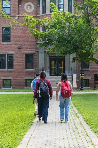 three students walking in the UPEI quad