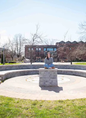 UPEI student Annika Masters in the stone theatre outside the Chaplaincy Centre