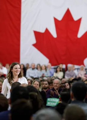 Kate VanGerven at a ministerial announcement with a large crowd