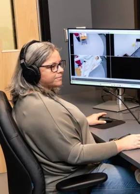 UPEI simulation coordinator Kerie Murphy using a computer