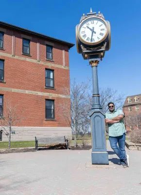 UPEI paramedicine student Bibin Peter by the UPEI clock