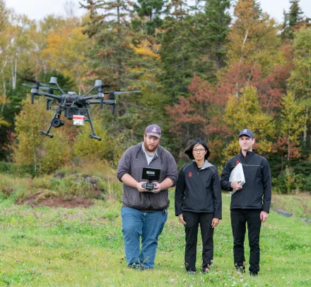 climate lab workers fly a drone