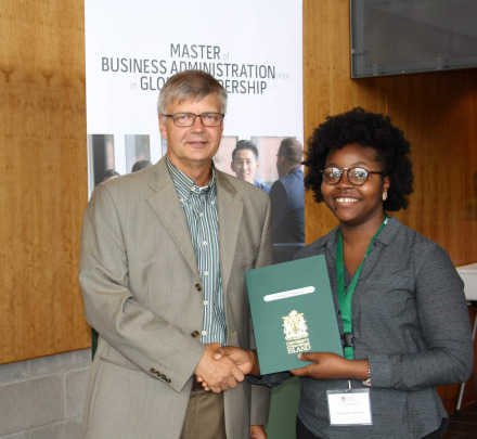 a student accepting an award from a faculty member