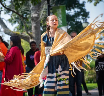 a ceremonial dancer wearing indigenous clothing