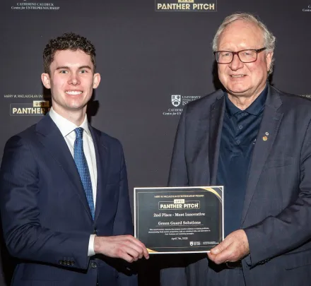 two people holding an award