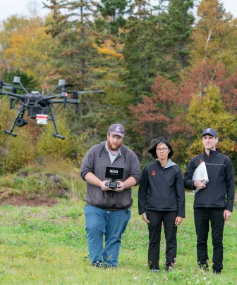 climate lab workers fly a drone
