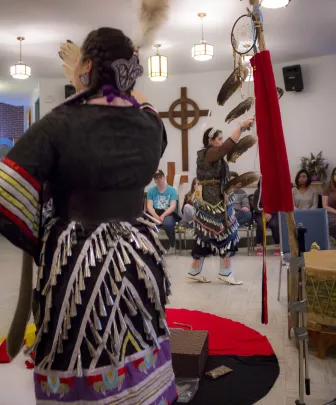 two indigenous women dancing in upei's chaplaincy centre