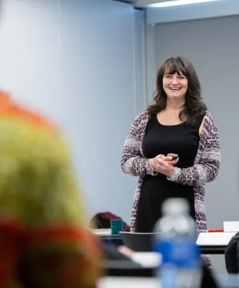 a facilitator smiling talking to a group