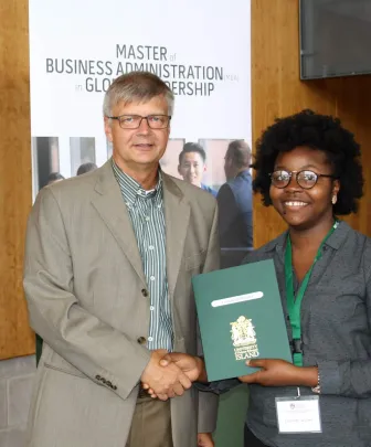a student accepting an award from a faculty member