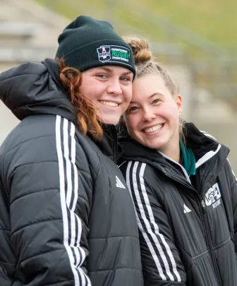 two smiling varsity rugby athletes