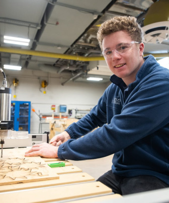 an engineering student wearing safety glasses working on a project