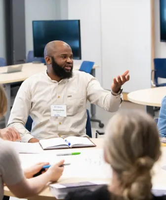 a small group speaking at a table