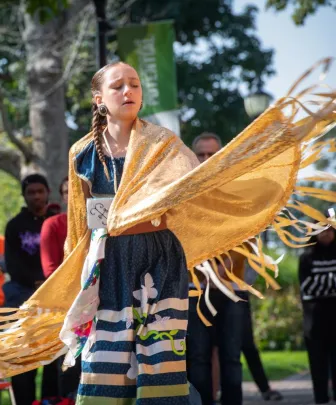a ceremonial dancer wearing indigenous clothing