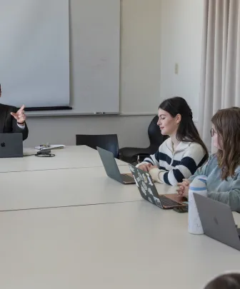 a professor leading a lecture with three students