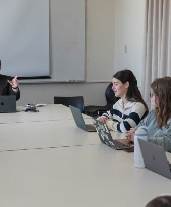 a professor leading a lecture with three students