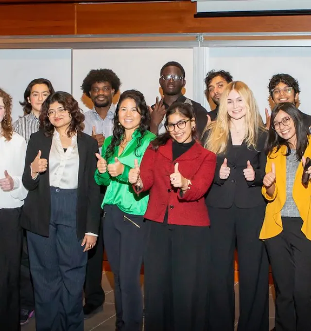 a large group of smiling students at night