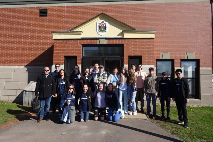 a group of students by UPEI's Cass Science Hall entrance