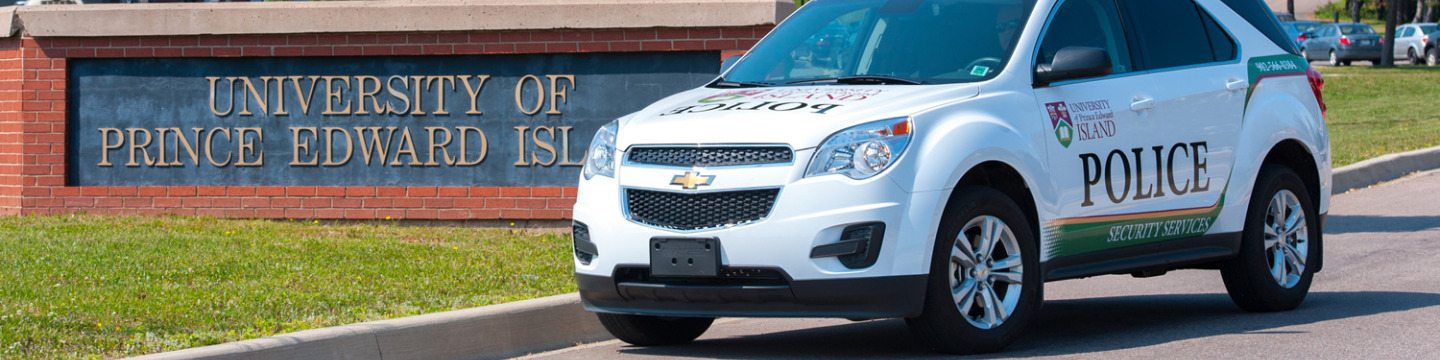 UPEI Security vehicle in front of university main entrance sign