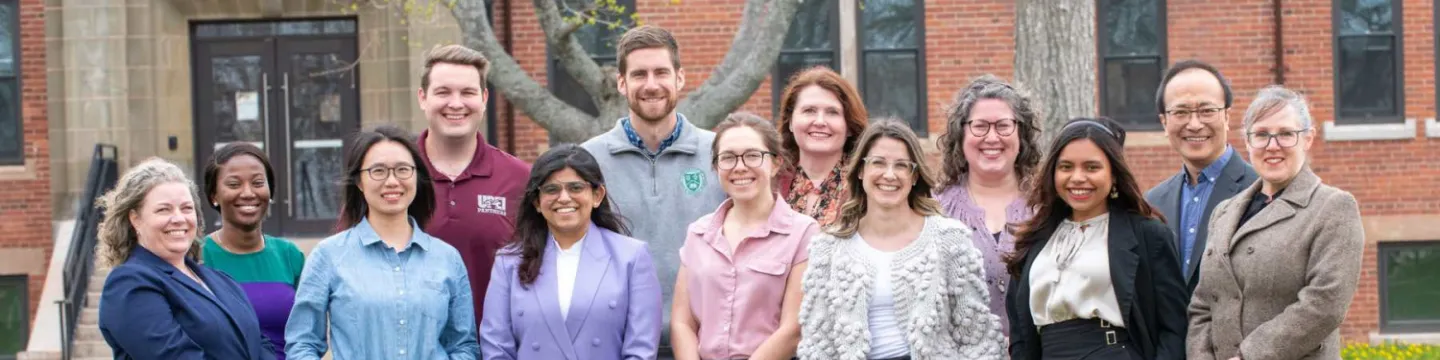 thirteen staff members of UPEI's recruitment and advising team in front of Dalton Hall