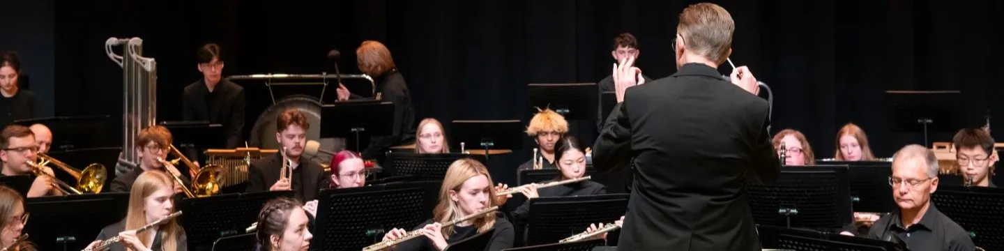 a conductor leading an orchestra