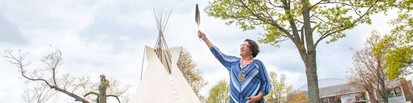 Doris Googoo holding an eagle feather